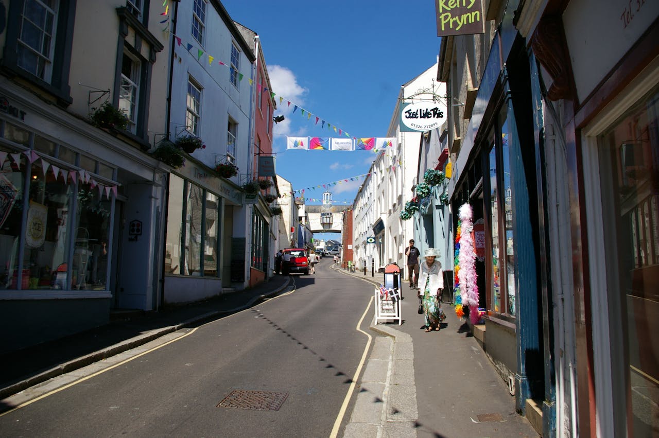 A vibrant street with colorful flags and signage on a sunny day.